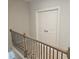 Hallway with wood and wrought iron railing and double closet at 3292 Lions Ruby Ln, Atlanta, GA 30349