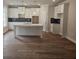 Modern kitchen with white cabinets, an island, dark backsplash, and an open layout at 3292 Lions Ruby Ln, Atlanta, GA 30349