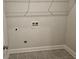 A functional laundry room features tile flooring, washer hookups and overhead wire shelving at 3292 Lions Ruby Ln, Atlanta, GA 30349