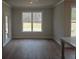 Living room with light gray walls, wood floors and access to outdoor patio at 3292 Lions Ruby Ln, Atlanta, GA 30349