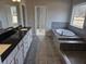 A luxurious main bathroom with a soaking tub, double vanity, and tiled floors at 3292 Lions Ruby Ln, Atlanta, GA 30349