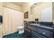 Bathroom with black vanity with a white toilet and shower behind a cream shower curtain at 3377 Fielders Point, Dacula, GA 30019