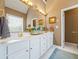 Bathroom features double sinks, white cabinets, a large mirror, and gold fixtures at 3377 Fielders Point, Dacula, GA 30019