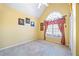 Bedroom features a large window with curtains, neutral walls, and carpet flooring at 3377 Fielders Point, Dacula, GA 30019