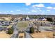 An exterior aerial view of the clubhouse with a vast parking lot and well-manicured grounds at 3377 Fielders Point, Dacula, GA 30019