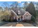 Charming brick home featuring a well-manicured lawn and inviting rocking chair front porch at 3377 Fielders Point, Dacula, GA 30019