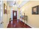 Bright foyer with decorative lighting, artwork, and beautiful hardwood flooring at 3377 Fielders Point, Dacula, GA 30019