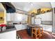 Stylish kitchen with white cabinetry, an island with seating, and hardwood floors at 3377 Fielders Point, Dacula, GA 30019