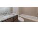 Bathroom with granite countertop, modern vanity, and a bathtub at 601 Cork St, Woodstock, GA 30188