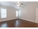 Bright bedroom featuring hardwood floors and plantation shutters at 601 Cork St, Woodstock, GA 30188