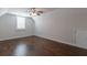 Spacious bedroom with hardwood floors and a window with shutters at 601 Cork St, Woodstock, GA 30188