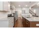 Kitchen with granite countertops, stainless steel appliances, and hardwood floors at 601 Cork St, Woodstock, GA 30188