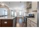 Open concept kitchen with island, stainless steel appliances and hardwood floors at 601 Cork St, Woodstock, GA 30188