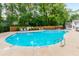 Community pool with wood fence and lounge chairs at 601 Cork St, Woodstock, GA 30188