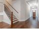 Elegant staircase with dark wood railing and hardwood floors at 601 Cork St, Woodstock, GA 30188