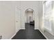 Hallway with freshly painted walls, an arched entryway and dark stained wood floors at 601 Formwalt Sw St, Atlanta, GA 30312