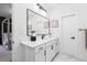 Modern bathroom with white cabinets, quartz countertop, and marble-tiled floors at 1076 Brookglynn Trce, Decatur, GA 30032