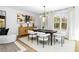 Modern dining room features a wood table, white chairs, and natural light at 1076 Brookglynn Trce, Decatur, GA 30032