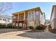 Back exterior showcasing large, covered deck, brickwork, and well-maintained yard at 221 Aster Ct, Canton, GA 30114