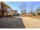 View of backyard featuring dry grass and minimal landscaping and several homes nearby at 221 Aster Ct, Canton, GA 30114