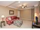 Inviting basement area with a comfortable sofa, ottoman, and a television at 221 Aster Ct, Canton, GA 30114