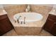 Modern bathroom with a soaking tub surrounded by elegant tile work and cabinetry at 221 Aster Ct, Canton, GA 30114