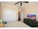 View of bedroom showing closet, TV and dresser, and entry to another room at 221 Aster Ct, Canton, GA 30114