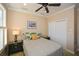 Cozy bedroom featuring neutral walls, ceiling fan, closet and charming decor at 221 Aster Ct, Canton, GA 30114