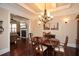 Formal dining room with wood floors, coffered ceiling, and elegant chandelier at 221 Aster Ct, Canton, GA 30114