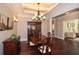 Spacious dining room featuring hardwood floors, a coffered ceiling, and an elegant chandelier at 221 Aster Ct, Canton, GA 30114