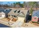 Well-maintained home showcasing a two-car garage, inviting front porch, and beautifully landscaped front yard at 221 Aster Ct, Canton, GA 30114