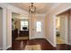 Elegant foyer showcasing hardwood floors, crown molding, and a view into the office and bedroom at 221 Aster Ct, Canton, GA 30114