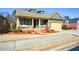 Inviting single-Gathering home boasts a covered front porch, well-maintained landscaping, and a convenient two-car garage at 221 Aster Ct, Canton, GA 30114