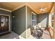 Cozy front porch featuring an outdoor fan and comfortable seating, ideal for relaxation at 221 Aster Ct, Canton, GA 30114