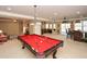 Expansive game room with a pool table, a bar area, and comfortable seating at 221 Aster Ct, Canton, GA 30114