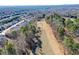 Scenic aerial view of a lush green golf course surrounded by trees and houses in a residential community at 221 Aster Ct, Canton, GA 30114