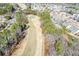 Scenic aerial view of a lush green golf course surrounded by trees and houses in a residential community at 221 Aster Ct, Canton, GA 30114