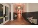 Hallway with paneled walls, wood floors, bench seating and decorative lighting at 221 Aster Ct, Canton, GA 30114