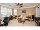 Bright living room with bay windows, plush seating, ceiling fan and carpet floors at 221 Aster Ct, Canton, GA 30114