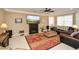 Spacious living room with a fireplace, plush seating, ceiling fan, and carpet floors at 221 Aster Ct, Canton, GA 30114