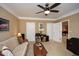 Neutral living space with sofa, carpet, ceiling fan, and access to other rooms at 221 Aster Ct, Canton, GA 30114