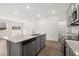 Open concept kitchen with island, gray cabinets, granite counters, and stainless steel appliances at 281 Kenoot Dr # 36, Mcdonough, GA 30253