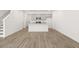 Spacious living room with vinyl plank flooring and access to kitchen and stairs at 281 Kenoot Dr # 36, Mcdonough, GA 30253