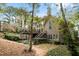 View of the home's backyard, highlighting the deck, landscaping, and mature trees at 580 Meadows Creek Dr, Johns Creek, GA 30005