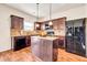 Kitchen with island and dark wood cabinets at 11119 Torino Dr, Hampton, GA 30228