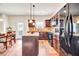 Kitchen with island, dark cabinets and black appliances at 11119 Torino Dr, Hampton, GA 30228