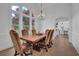 Elegant dining room with hardwood floors, chandelier, and large windows at 3060 Cabernet Ct, Cumming, GA 30041