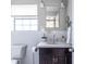 Charming bathroom featuring a vanity, accent mirror, and tile flooring at 410 Candler Park Ne Dr # C-1, Atlanta, GA 30307