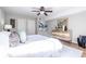 Bedroom features a ceiling fan, ensuite bath, and hardwood floors at 410 Candler Park Ne Dr # C-1, Atlanta, GA 30307