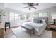 Bright bedroom features a ceiling fan, bench, and large windows at 410 Candler Park Ne Dr # C-1, Atlanta, GA 30307